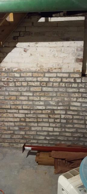 Historic basement brick wall after cleaning and restoration in Omaha