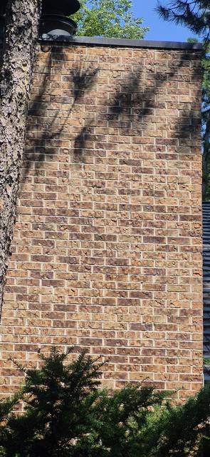 Tall brick chimney chase restored on an Omaha home