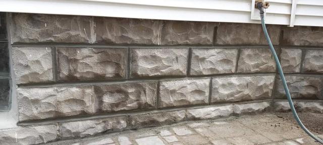 Close-up of repointed mortar joints on a rock-faced foundation in Omaha