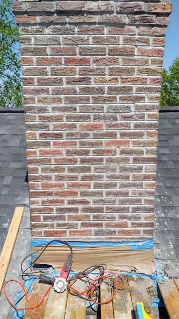 Historic brick chimney in Omaha after tuckpointing with fresh color-matched mortar joints