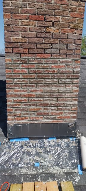 Historic chimney mid-tuckpointing in Omaha, lower courses repointed and upper courses still original