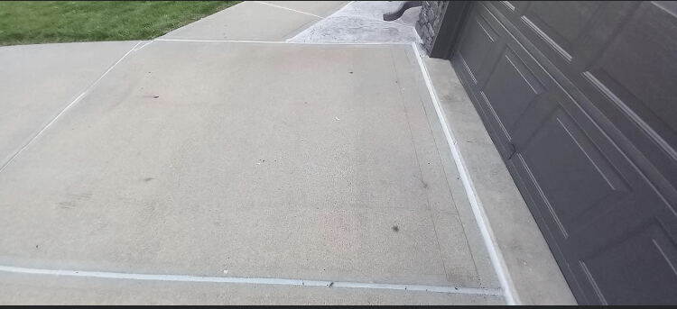 Driveway expansion joints freshly caulked in Omaha